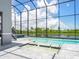 Beautiful outdoor pool with jacuzzi and tranquil lake views, enclosed in a modern screened-in lanai at 5630 Inspiration Ter, Bradenton, FL 34210