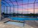A luxurious pool and spa is surrounded by a screened enclosure, offering stunning views of the backyard at 5630 Inspiration Ter, Bradenton, FL 34210