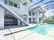 Outdoor pool enclosed in a screened in lanai, with stairs up to the second floor, and a jacuzzi at 5630 Inspiration Ter, Bradenton, FL 34210