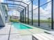 Large screened in pool and jacuzzi with view of the lake, attached to a modern home at 5630 Inspiration Ter, Bradenton, FL 34210