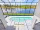 Stunning aerial view of the backyard pool, with views of the lake and surrounding nature at 5630 Inspiration Ter, Bradenton, FL 34210