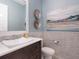 Stylish powder room featuring a modern vessel sink, unique wall decor, and elegant mosaic tile accents at 5630 Inspiration Ter, Bradenton, FL 34210