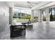 Cozy sunroom with stylish furniture, large windows offering scenic views of the lawn and water at 5630 Inspiration Ter, Bradenton, FL 34210