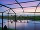 A serene view of the natural landscape is seen from the screened enclosure at 5630 Inspiration Ter, Bradenton, FL 34210