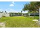 Large backyard featuring a shed, mature trees, well-manicured lawn, and a sunroom at 5685 36Th N Ave, St Petersburg, FL 33710