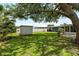 Backyard with large shade tree, shed, and lush lawn at 5685 36Th N Ave, St Petersburg, FL 33710