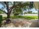 Expansive backyard featuring a paver patio and storage shed, shaded by a large tree at 5685 36Th N Ave, St Petersburg, FL 33710