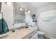 Clean bathroom with marble countertops, vanity, walk-in shower and decorative shelving at 5685 36Th N Ave, St Petersburg, FL 33710