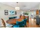 Bright dining room features hardwood floors and a round wooden table with seating for six at 5685 36Th N Ave, St Petersburg, FL 33710
