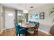 Bright dining room features hardwood floors and a round wooden table with seating for six at 5685 36Th N Ave, St Petersburg, FL 33710