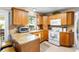 Well-lit kitchen featuring tile countertops, light cabinets, and white appliances at 5685 36Th N Ave, St Petersburg, FL 33710