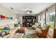 Cozy living room featuring hardwood floors, comfortable seating, and plenty of natural light at 5685 36Th N Ave, St Petersburg, FL 33710