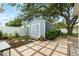 Backyard view of the storage shed with double doors and a beautifully landscaped surrounding at 5685 36Th N Ave, St Petersburg, FL 33710