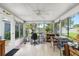 Bright sunroom with tiled floors, ceiling fan, and large windows offering plenty of natural light at 5685 36Th N Ave, St Petersburg, FL 33710
