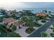Breathtaking aerial view of a waterfront community with stunning homes, lush landscaping, and canal access to the open bay at 571 Birdie Ln, Longboat Key, FL 34228
