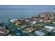 Aerial view of a waterfront property with a pool, dock, and boat lift in a desirable community at 571 Birdie Ln, Longboat Key, FL 34228
