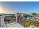 This scenic balcony showcases ornate iron railings, stone pillars, and panoramic views of the surrounding waterways at 571 Birdie Ln, Longboat Key, FL 34228