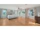 Spacious bedroom boasts hardwood floors, natural light from the water view, and access to a private balcony at 571 Birdie Ln, Longboat Key, FL 34228