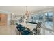 Stylish dining area with a marble table, unique zebra-print chairs, and access to the waterfront views at 571 Birdie Ln, Longboat Key, FL 34228