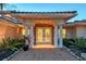 Beautifully designed front entrance with white columns, stone accents, and lush landscaping, creating a warm and inviting welcome at 571 Birdie Ln, Longboat Key, FL 34228