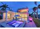 Waterfront home with a pool, spa, balconies, and manicured landscaping at 571 Birdie Ln, Longboat Key, FL 34228