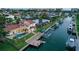 Beautiful canal-front home featuring a private dock, boat lift, and backyard swimming pool at 571 Birdie Ln, Longboat Key, FL 34228