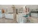 Elegant kitchen with a center island, bar seating, and modern appliances at 571 Birdie Ln, Longboat Key, FL 34228