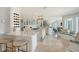 Open kitchen with marble countertops, stainless steel appliances and bar seating for entertaining at 571 Birdie Ln, Longboat Key, FL 34228