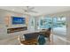 Inviting living room with canal views, a modern fireplace, and stylish furnishings at 571 Birdie Ln, Longboat Key, FL 34228