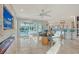 Bright living room with modern furnishings, open to bar and pool area via sliding doors at 571 Birdie Ln, Longboat Key, FL 34228