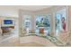 Cozy living area features canal views, a stone fireplace, and comfortable seating at 571 Birdie Ln, Longboat Key, FL 34228