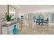 Open-concept living area with marble floors, modern decor, and seamless transition to the outdoor space through sliding glass doors at 571 Birdie Ln, Longboat Key, FL 34228