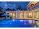 Waterfront home with a pool, spa, outdoor seating, and manicured landscaping at 571 Birdie Ln, Longboat Key, FL 34228