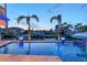 Stunning waterfront pool area with palm trees, a dock, and gorgeous water views at 571 Birdie Ln, Longboat Key, FL 34228