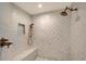 Tiled walk-in shower with a mosaic tile pattern and bronze fixtures at 571 Birdie Ln, Longboat Key, FL 34228