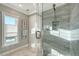 Modern shower featuring gray tile surround and clear glass door at 571 Birdie Ln, Longboat Key, FL 34228