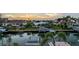 Sunset waterfront view featuring private docks and boat lifts, mature tropical trees and the intercoastal waterways at 571 Birdie Ln, Longboat Key, FL 34228