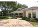 Charming backyard patio with ample seating surrounded by lush landscaping and mature trees at 5803 Garden Lakes Palm, Bradenton, FL 34203