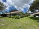 Spacious backyard with lots of plants, landscaping, and a tile roofed home at 5803 Garden Lakes Palm, Bradenton, FL 34203
