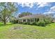 Beautiful backyard view of the back of the house surrounded by lush landscaping at 5803 Garden Lakes Palm, Bradenton, FL 34203