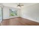 This bedroom offers a ceiling fan and views of the back yard and waterway at 5803 Garden Lakes Palm, Bradenton, FL 34203