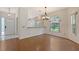 Bright dining room features hardwood floors and ample natural light from the large, arched windows at 5803 Garden Lakes Palm, Bradenton, FL 34203