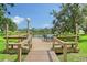 Wooden dock with seating, providing stunning lake views and a relaxing atmosphere at 5803 Garden Lakes Palm, Bradenton, FL 34203