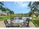 Charming dockside patio set overlooking the lake, perfect for outdoor dining and gatherings at 5803 Garden Lakes Palm, Bradenton, FL 34203