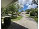 Long driveway leading up to a well-maintained home with lush greenery on either side at 5803 Garden Lakes Palm, Bradenton, FL 34203