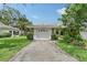 View of the garage and front entrance of the home at 5803 Garden Lakes Palm, Bradenton, FL 34203