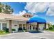 Exterior view of the community center with a covered entrance and well-manicured landscaping at 5803 Garden Lakes Palm, Bradenton, FL 34203