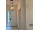 Bright foyer with tile flooring, a modern pendant light, and a clear view of the front door and sidelight window at 5803 Garden Lakes Palm, Bradenton, FL 34203