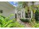 Property's front entrance with tropical landscaping flanking the walkway at 5803 Garden Lakes Palm, Bradenton, FL 34203