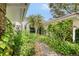 Lush landscaping surrounds the walkway to this property's front entrance at 5803 Garden Lakes Palm, Bradenton, FL 34203